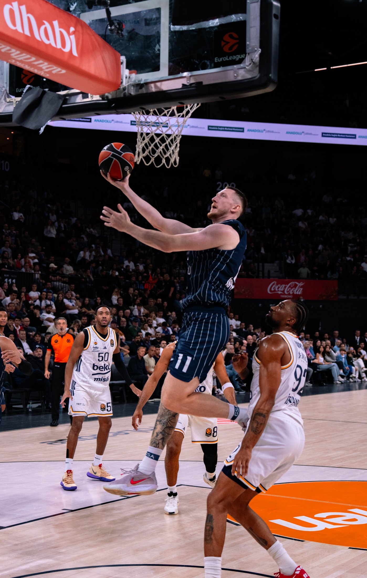 Basketball player driving toward the hoop for a layup